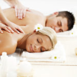 Romantic couple is having a back massage in spa center.